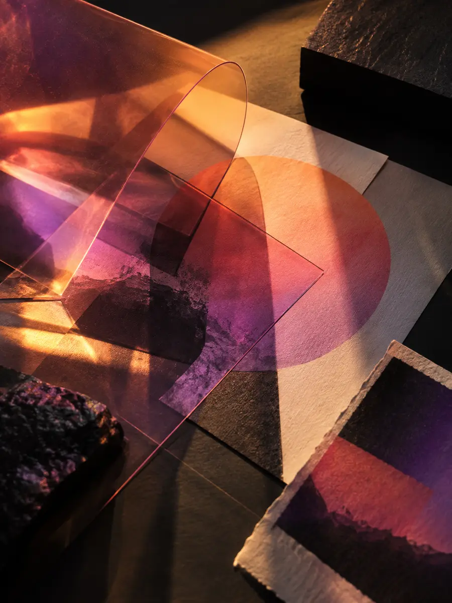 Printed color studies and translucent materials arranged on a creative studio table